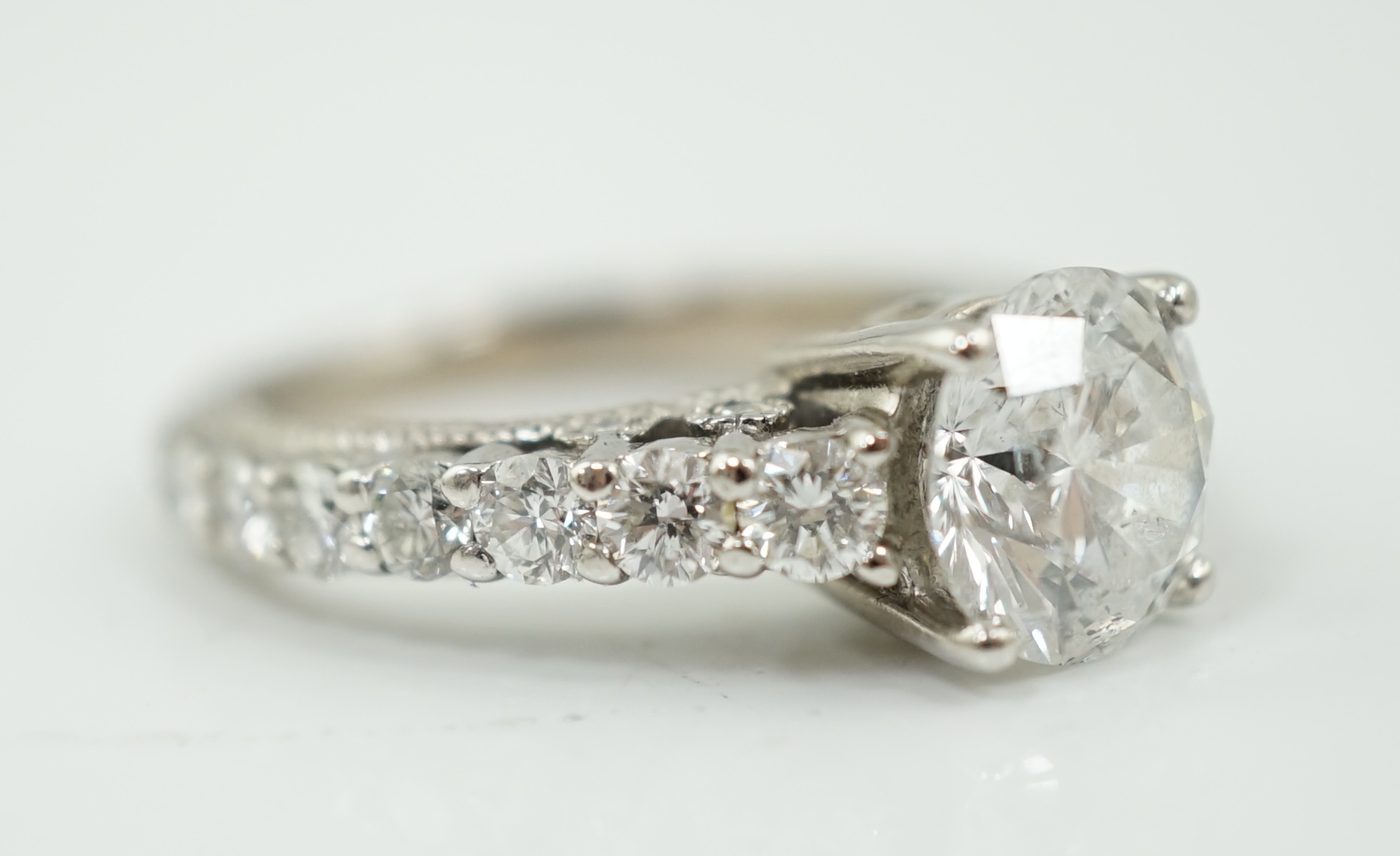 A modern 18ct white gold and single stone diamond set ring, with twenty eight graduated diamond set shank and setting